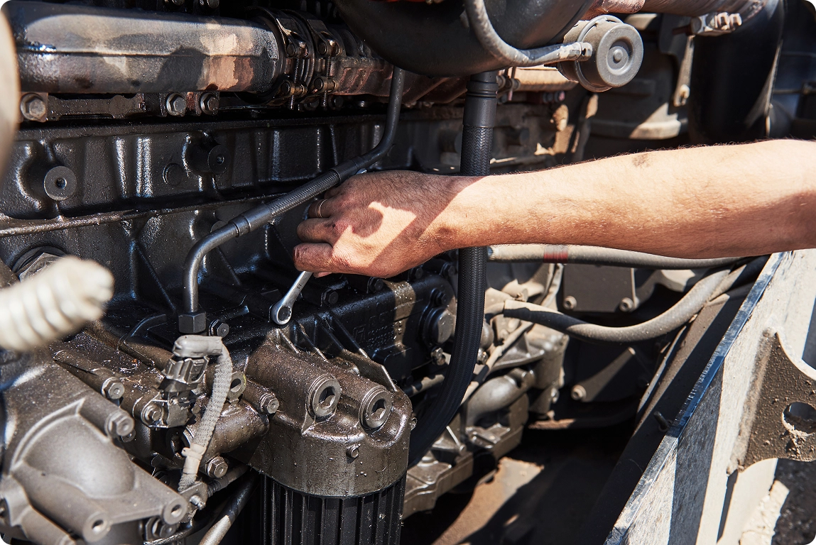 hands of repairman mechanic working on engine