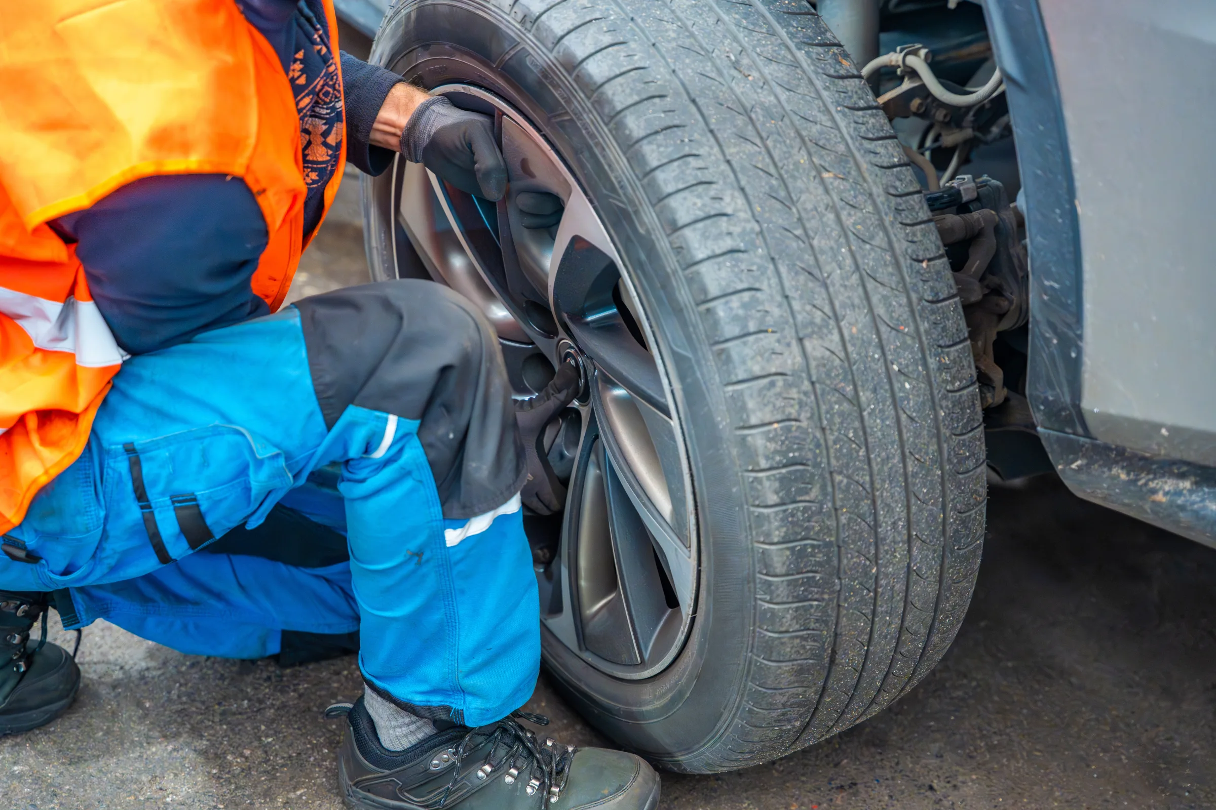 mechanic rotating SUV tires in a Minnesota auto shop