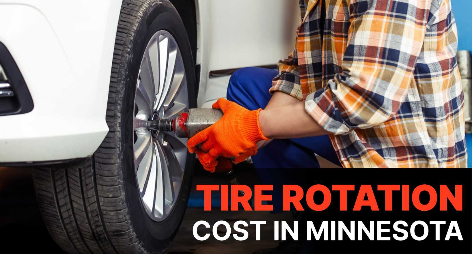 mechanic rotating SUV tires in a Minnesota auto shop