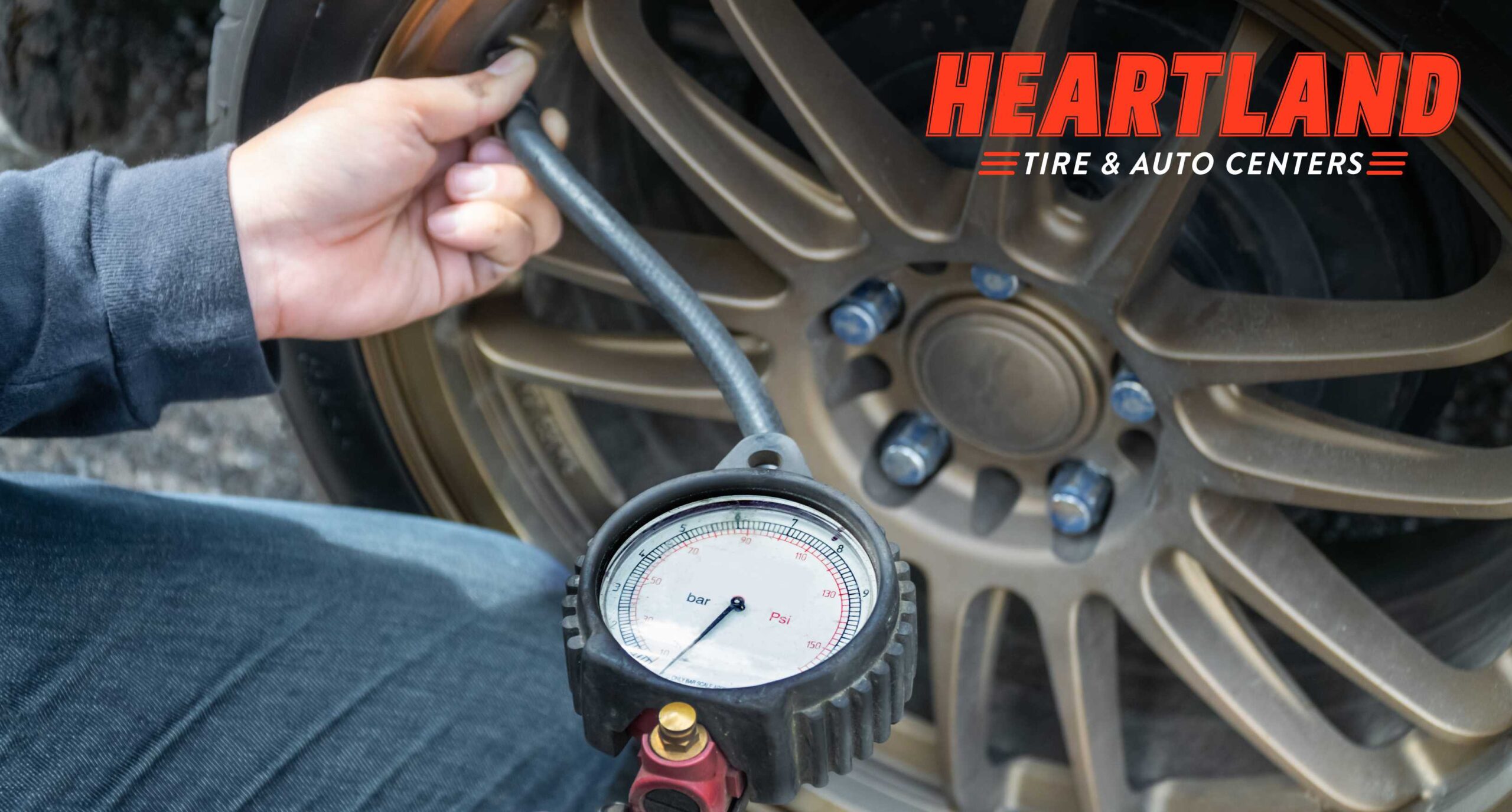 Technician checking tire pressure on a vehicle during August in Minnesota