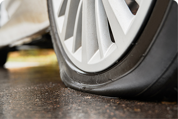 Flat tire on a vehicle showing tire damage requiring professional flat tire repair service