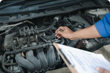 Auto technician inspecting a vehicle engine during a professional engine diagnostic and repair service